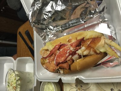 My first lobster roll from Karen's place. Dry. No mayo. Just a grilled roll with lobster  meat and drawn butter poured over it.