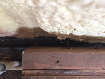 The screws only go through the boards, not into a stud.  Aside from the right side attachment, it just rests on the floor. I just took this image; the trim on top of board now showing was just added.