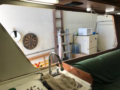 If you zoom in you can see damage to paneling by the sink, but no water damage to window opening. So leak was from clogged corner window drain, my drain was clogged, water over flowed the window track/frame and ran onto counter top. You can also see very minor water damage to opposite bottom corner behind couch.