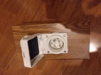 twist lock inlet installed on particle board for test fitting