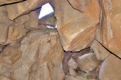 A chockstone guards the cave entrance